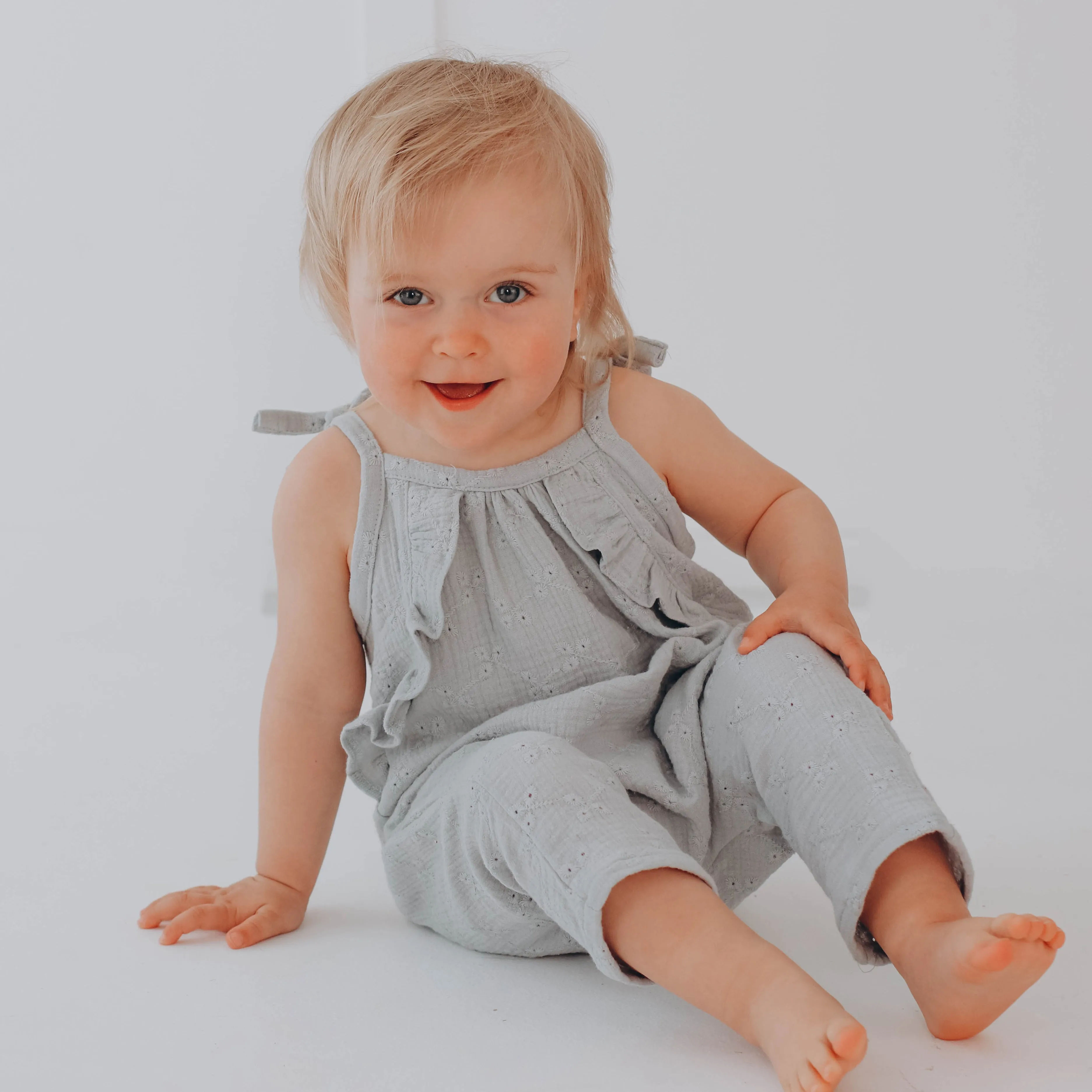 Embroidered muslin long leg romper with frills